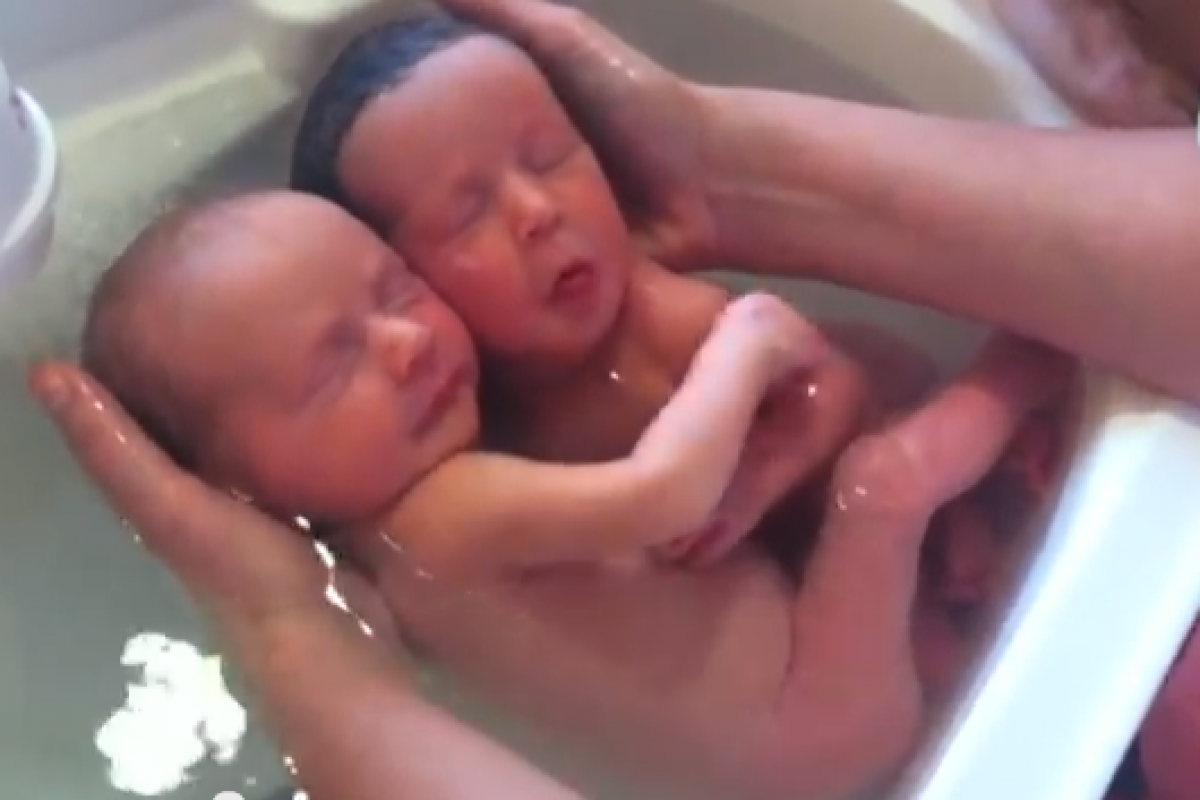Νεογέννητα δίδυμα απολαμβάνουν αγκαλιασμένα το μπάνιο τους (Δείτε το!)