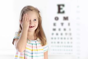 Child at eye sight test. Little kid selecting glasses at optician store. Eyesight measurement for school kids. Eye wear for children. Doctor performing eye check. Baby with spectacles top view.